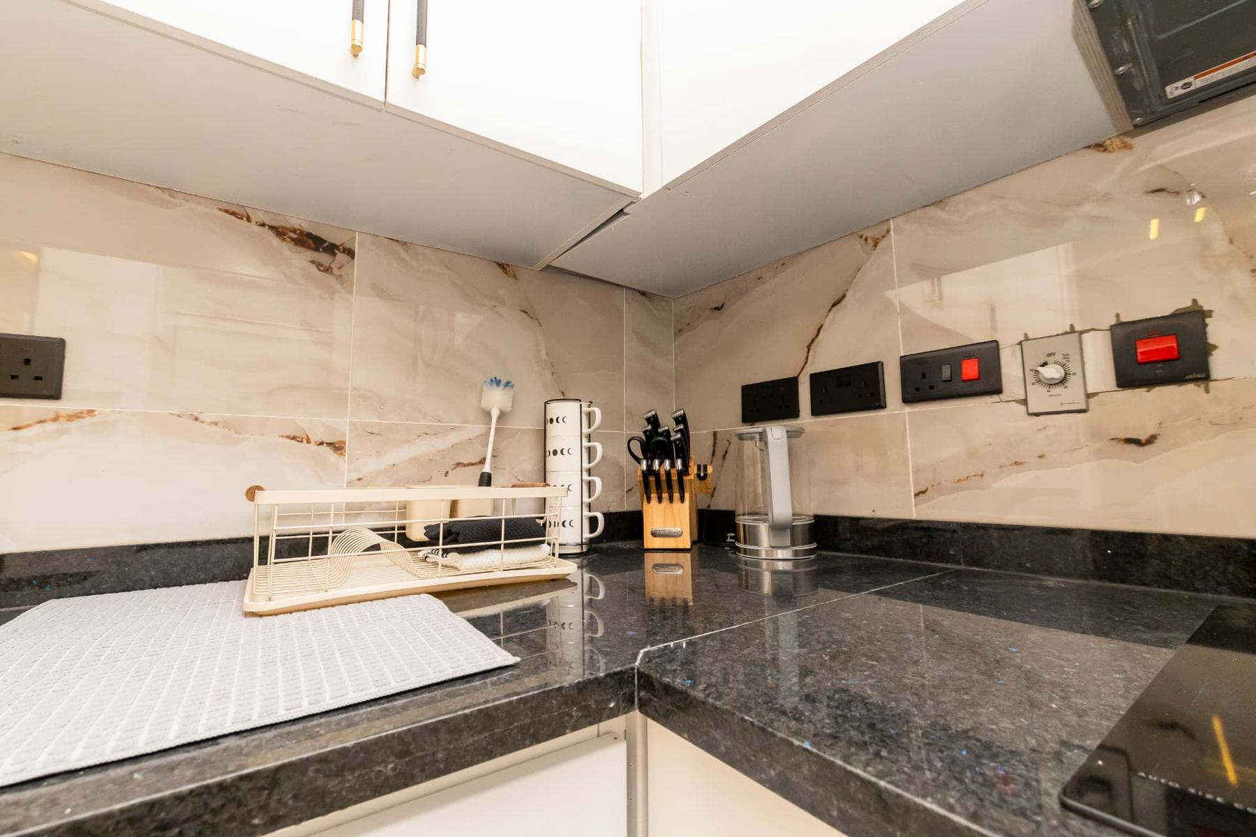 Penthouse kitchen counter with granite worktop, kettle and knife block