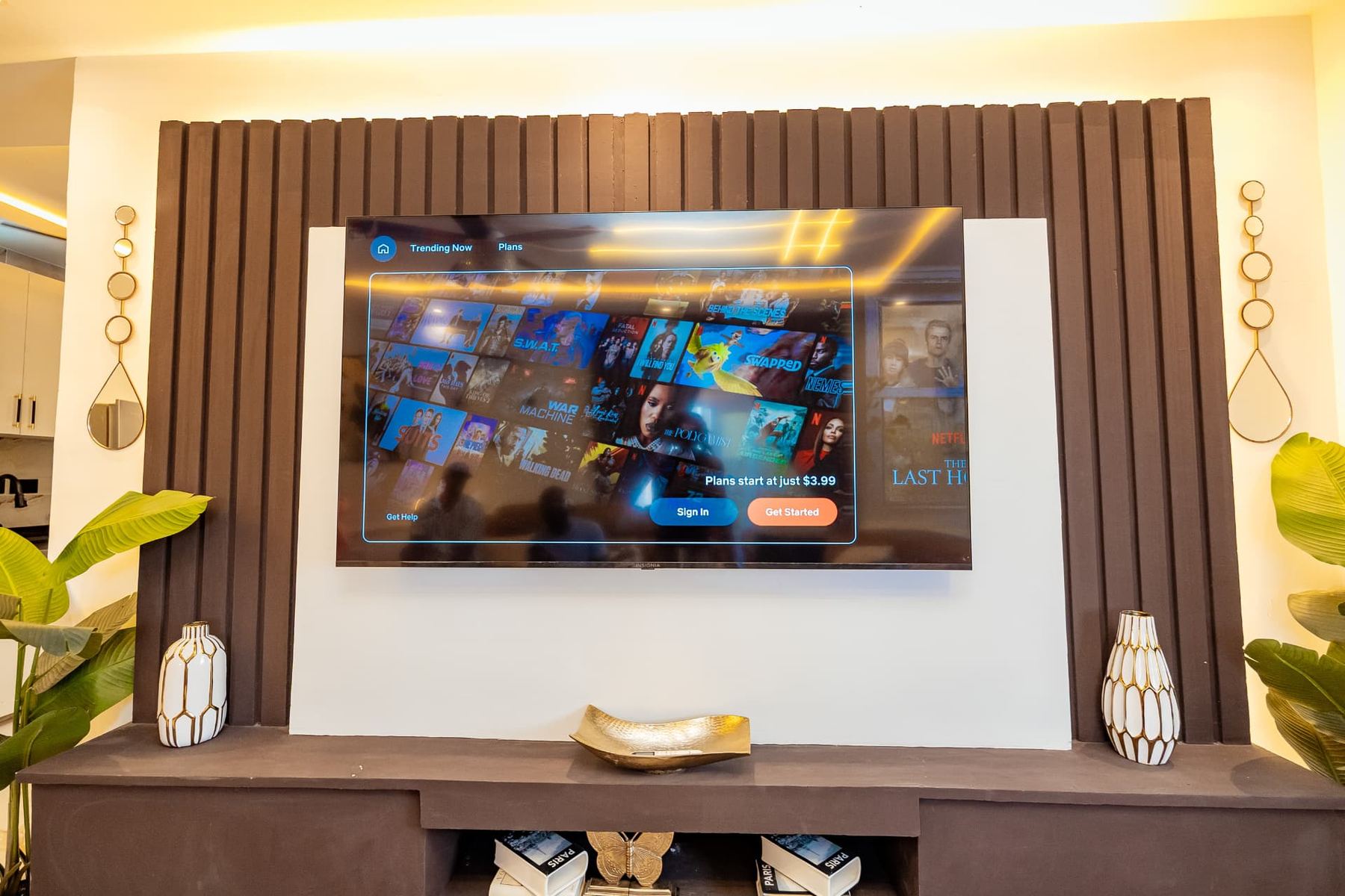Penthouse fluted media wall with large smart TV and brass decor