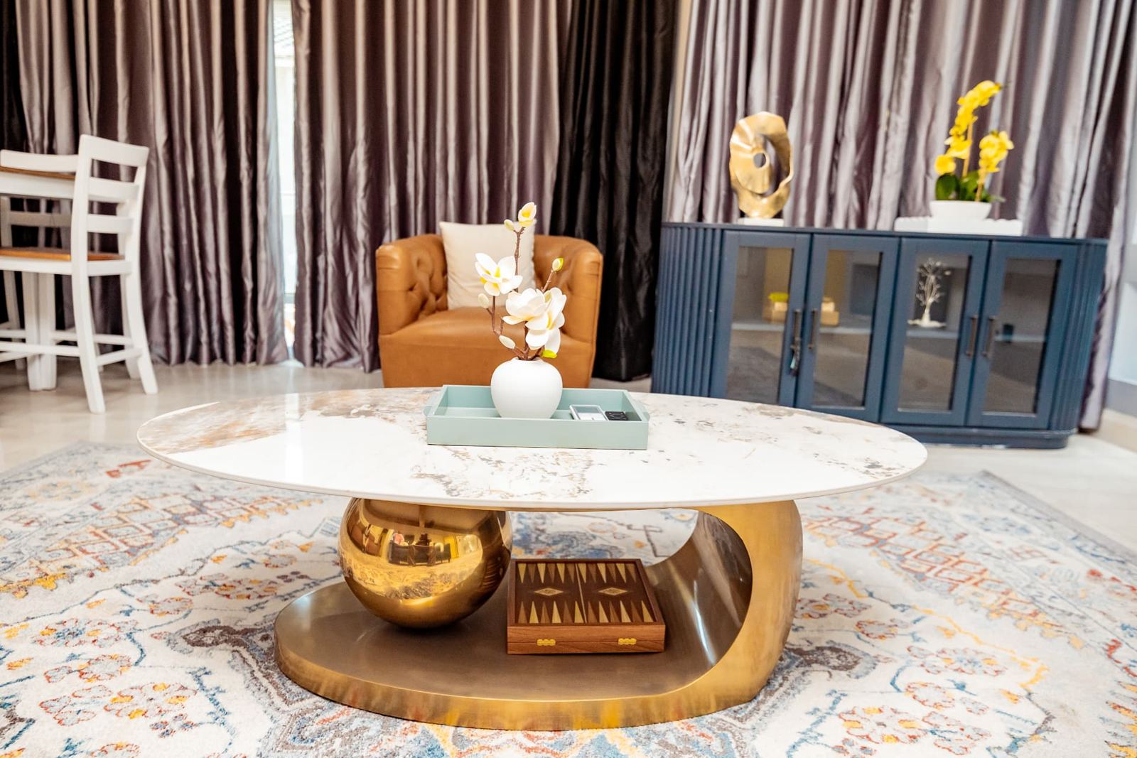 Marble and brass coffee table on a patterned rug in the two-bedroom lounge