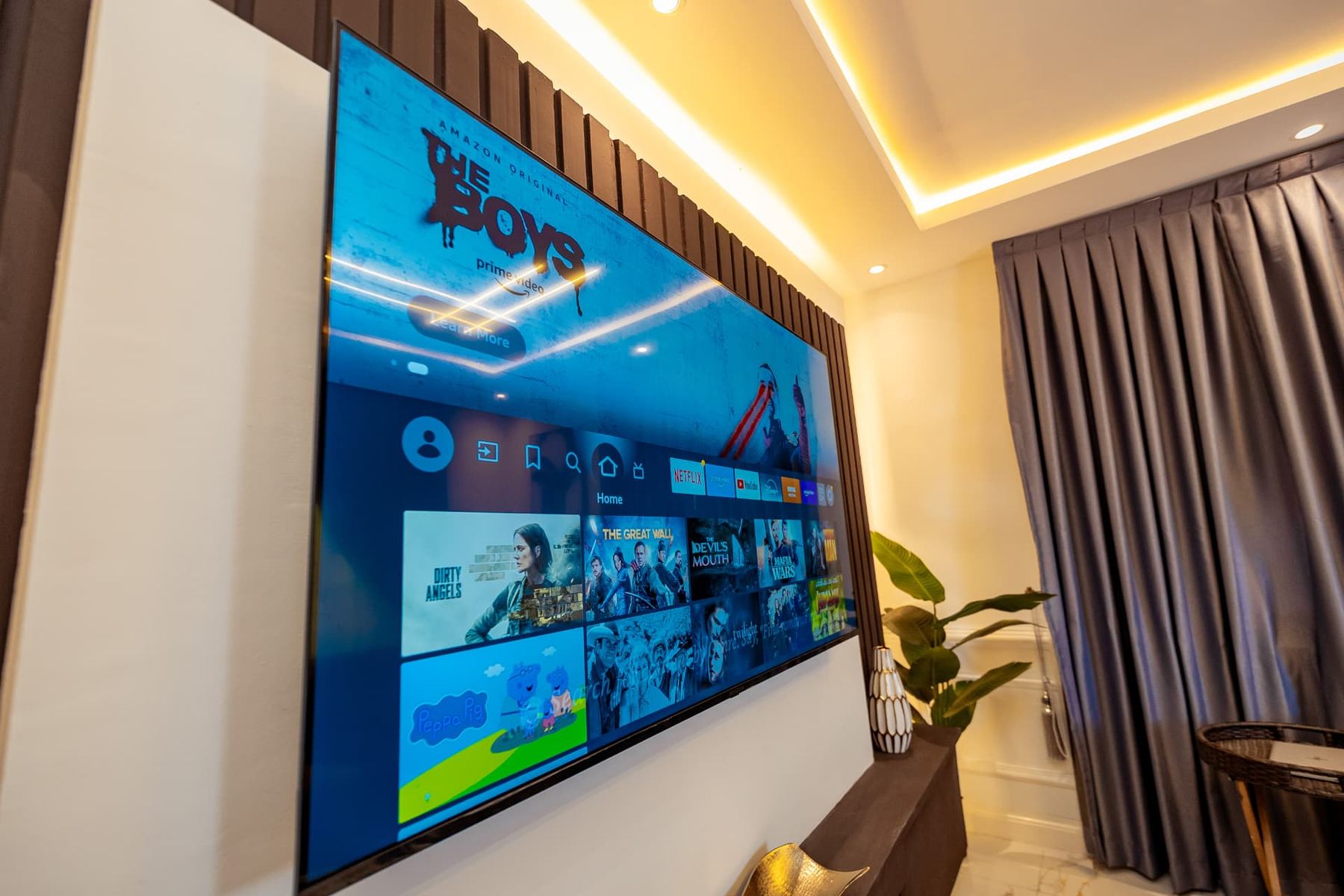 Penthouse smart TV with streaming apps on the fluted feature wall