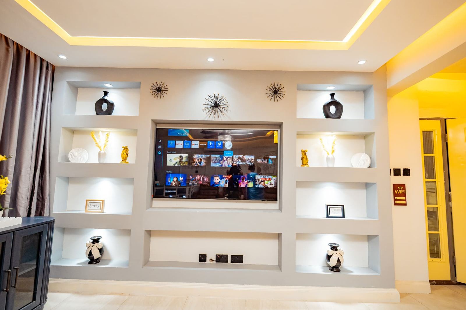 Built-in display wall with smart TV and lit niches