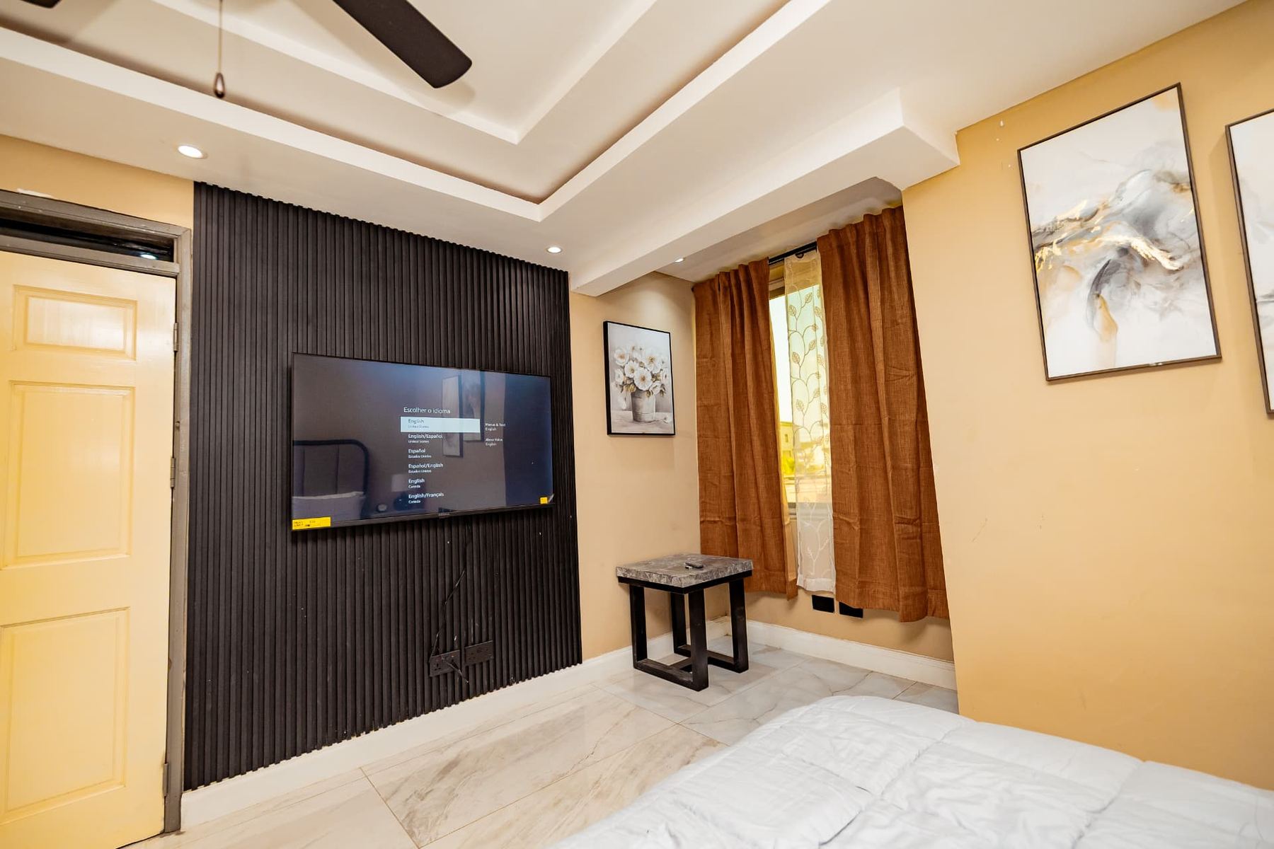 Unit 106 bedroom fluted black feature wall with wall-mounted smart TV
