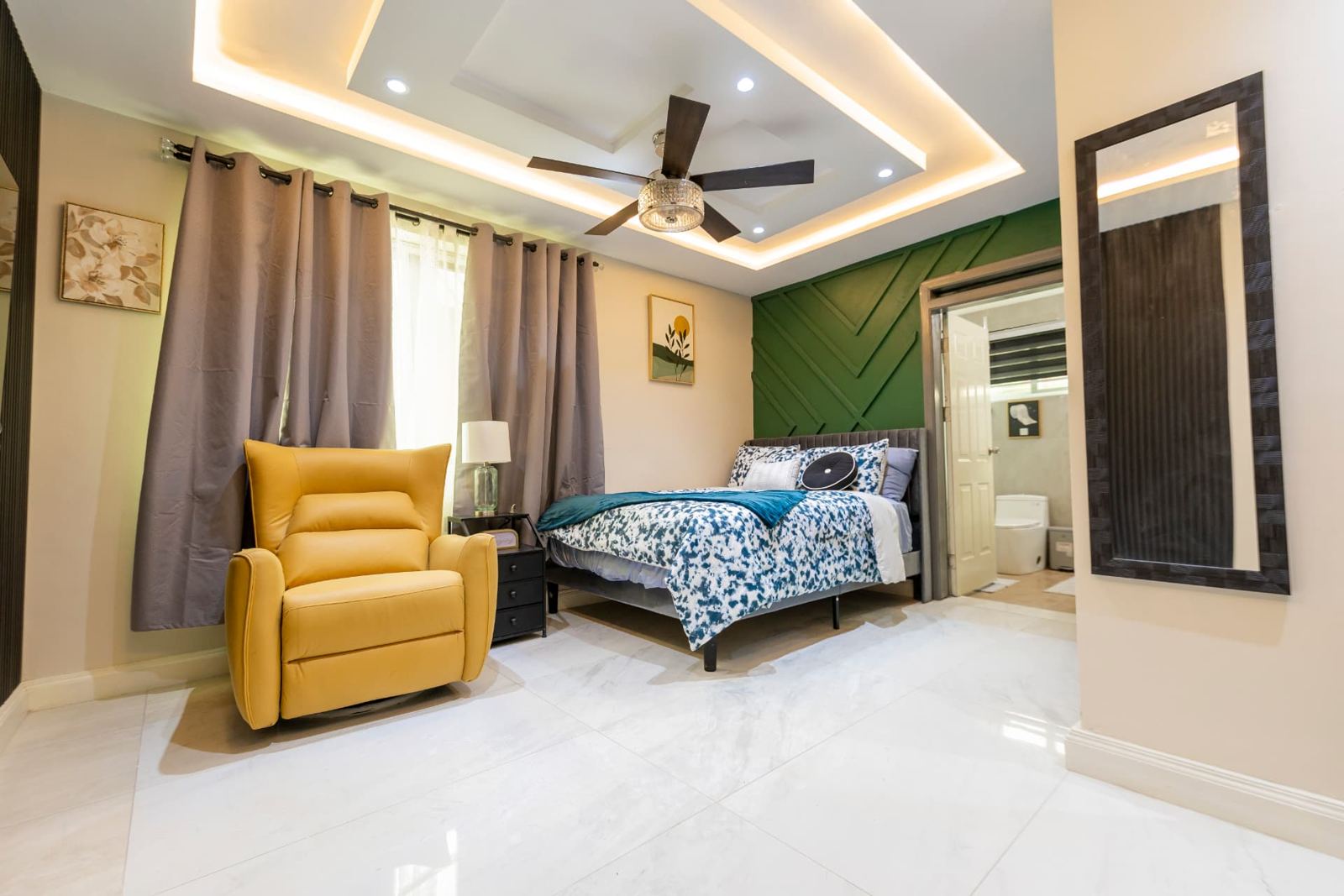 Second bedroom with queen bed, recliner and en-suite bathroom
